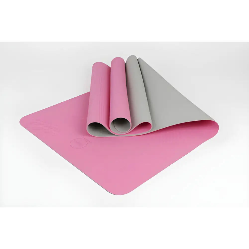 Pink and gray yoga mat partially rolled, showcasing the Tone TPE Premium design