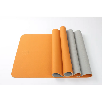 Partially rolled Premium TPE Yoga Mat in vibrant orange and gray design