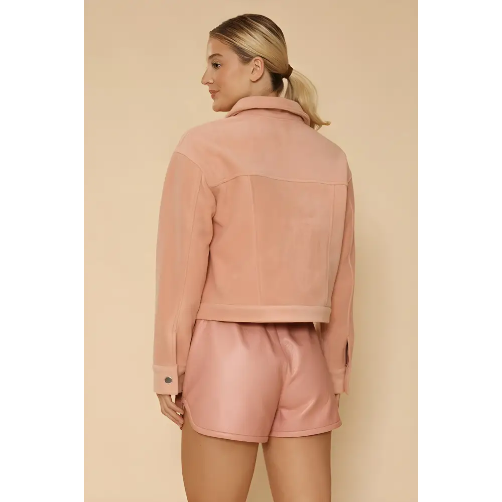 Woman in a pink fleece bow jacket and shorts showcasing trendy summer style