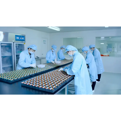 Workers in sterile lab handling vials for Rapid Testing MPOCT and medical instrument class III