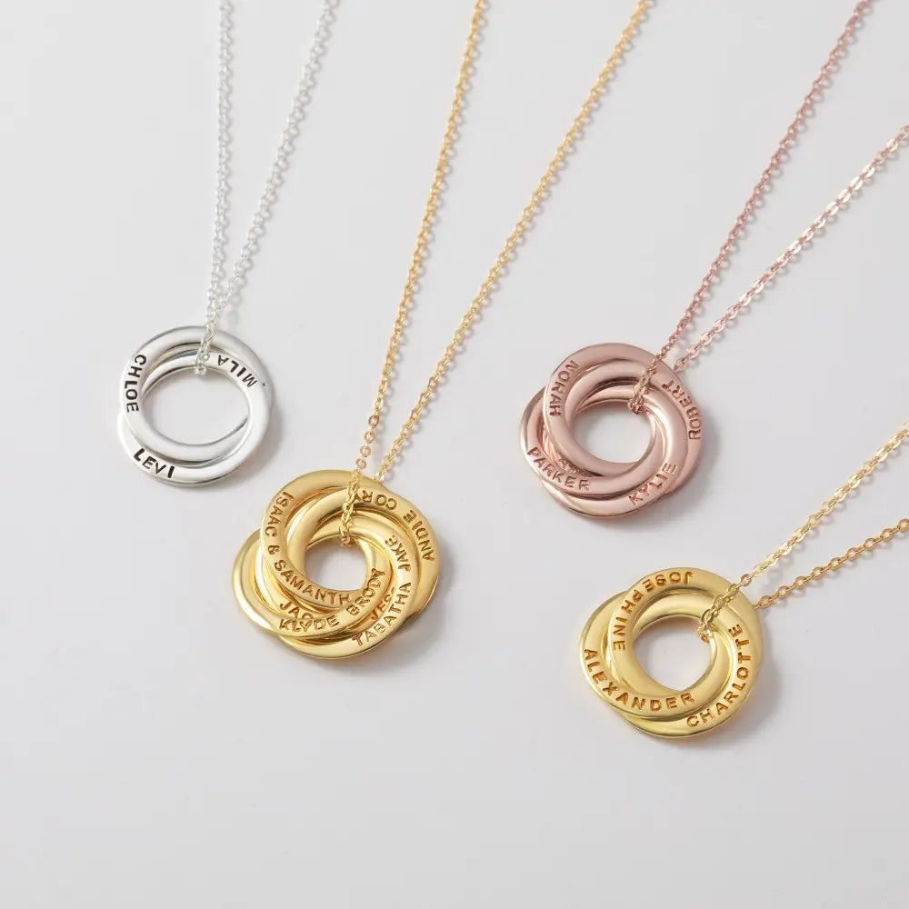 Interlocking personalized name necklaces in silver, gold, and rose gold for family