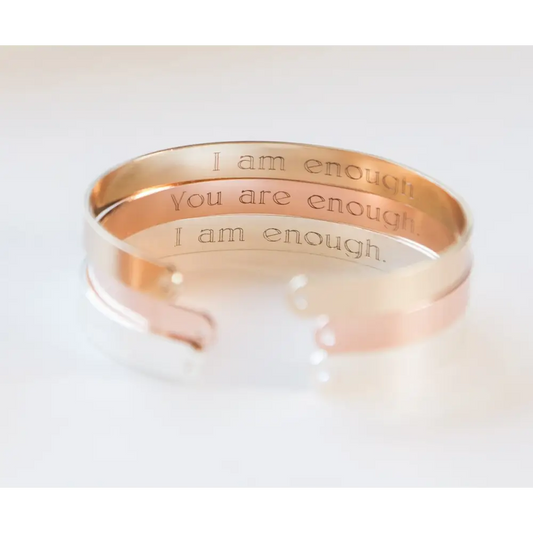 Stacked rose gold plated bracelets featuring engraved secret messages for daily inspiration