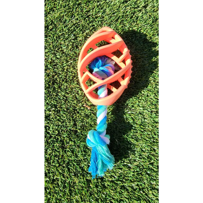 Orange rubber football dog chew toy with blue and white tug rope for playful pups