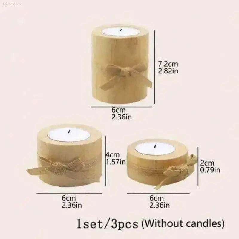 Set of three wooden candle holders with bows.