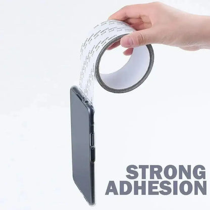 Double-sided adhesive tape holding a phone for Screen Repair Tape Fixes Nets Fast