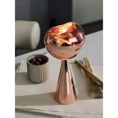 Stylish copper-colored reflective sculptural modern table lamp for a chic decor