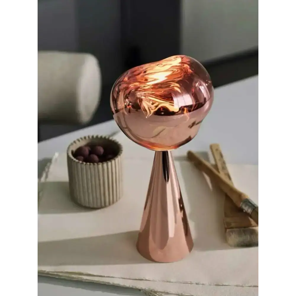 Copper cone-shaped reflective glass in a Sculptural Modern Table Lamp design