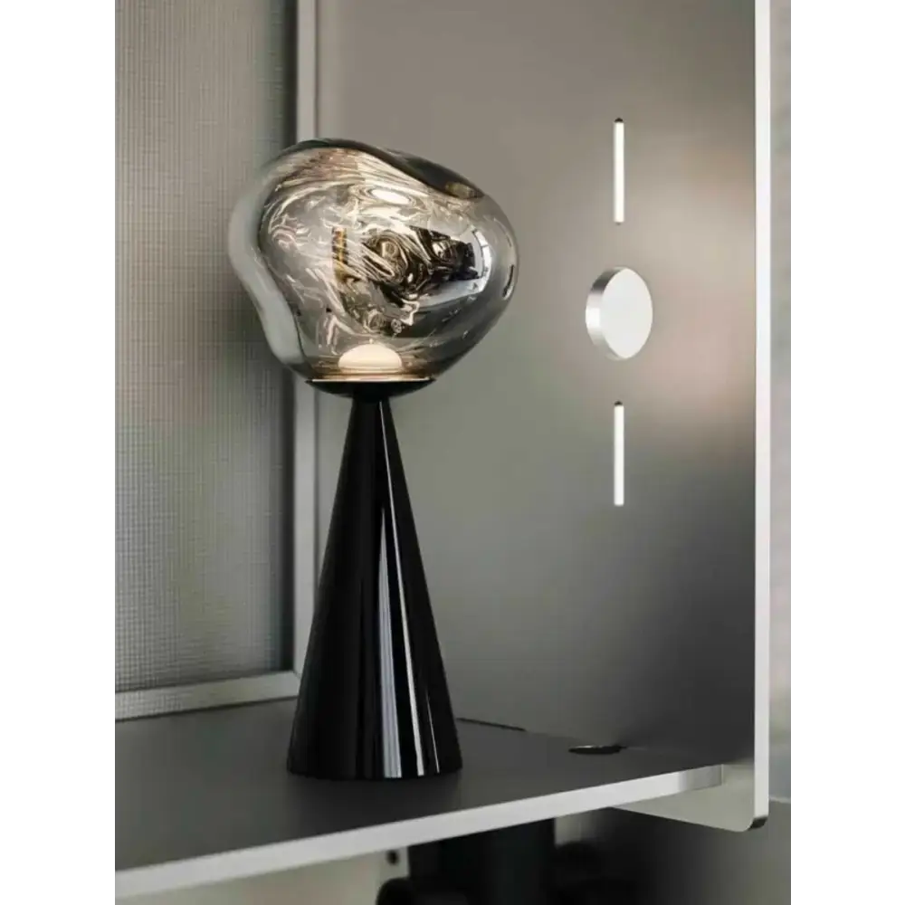 Black cone-based lamp with silver shade in a Sculptural Modern Table Lamp design