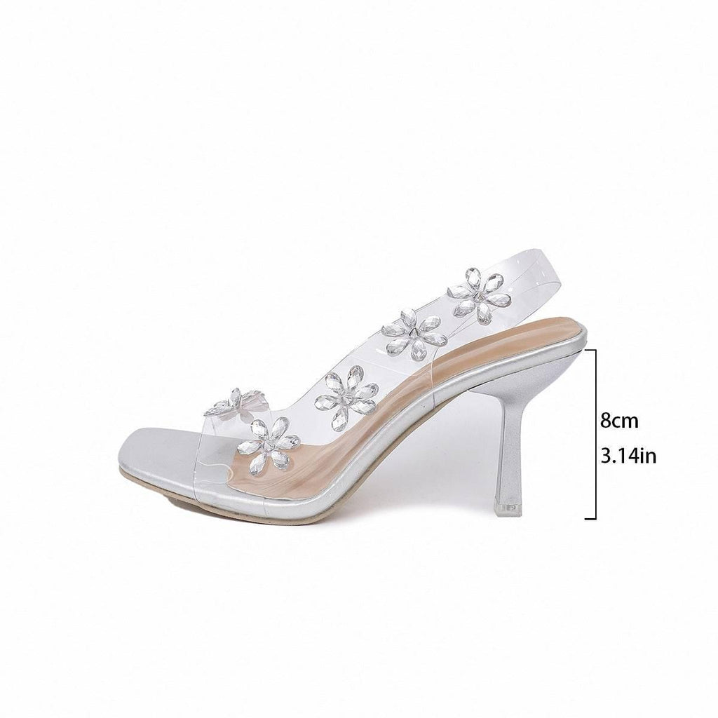 Shimmering Bloom: Chic Silver Sandals with Floral Embellishments - Estalios
