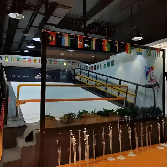 Indoor ski slope with flags showcasing a Ski Simulator Indoor Training Machine experience