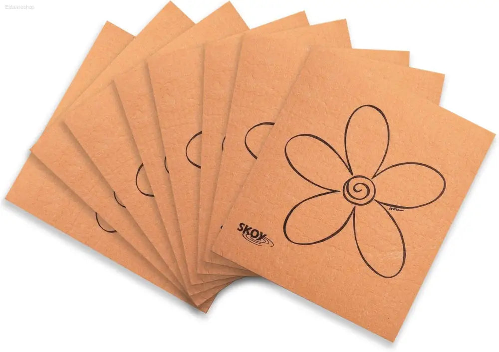 Stack of tan cloths with flower design.