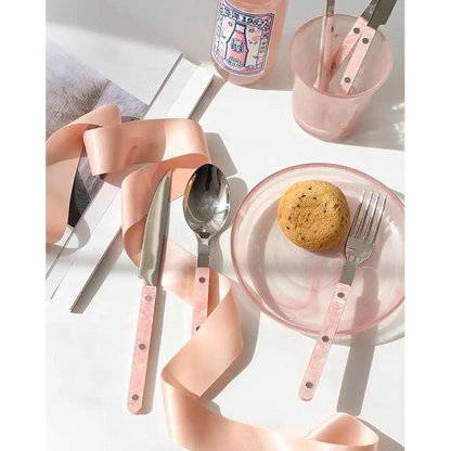 Sleek Modern Pinky Flatware Set featuring pink-handled cutlery, plate, and drink