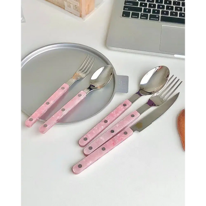 Sleek Modern Pinky Flatware Set featuring pink-handled stainless steel cutlery