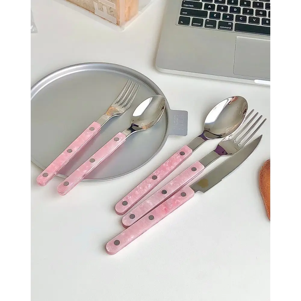 Sleek Modern Pinky Flatware Set featuring stylish pink-handled cutlery for chic dining