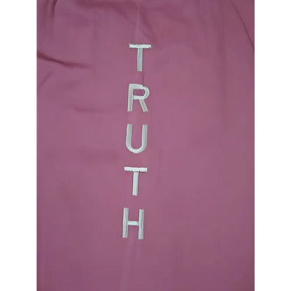 Pink fabric with embroidered TRUTH on a stylish mat bag for yogis