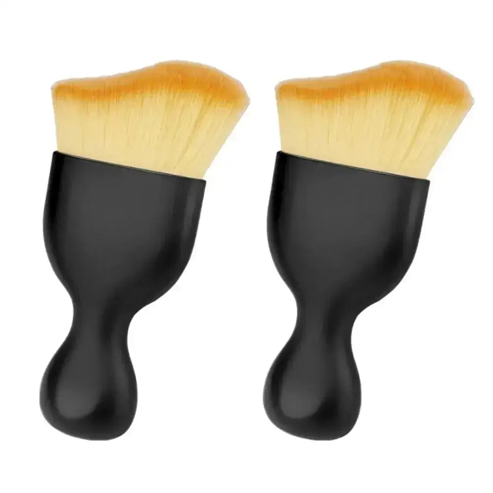 Two black-handled makeup brushes from the Soft Brush Trio for car interior dust