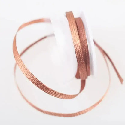 Copper-colored ribbon on a white spool for Solder Wire Desoldering tasks