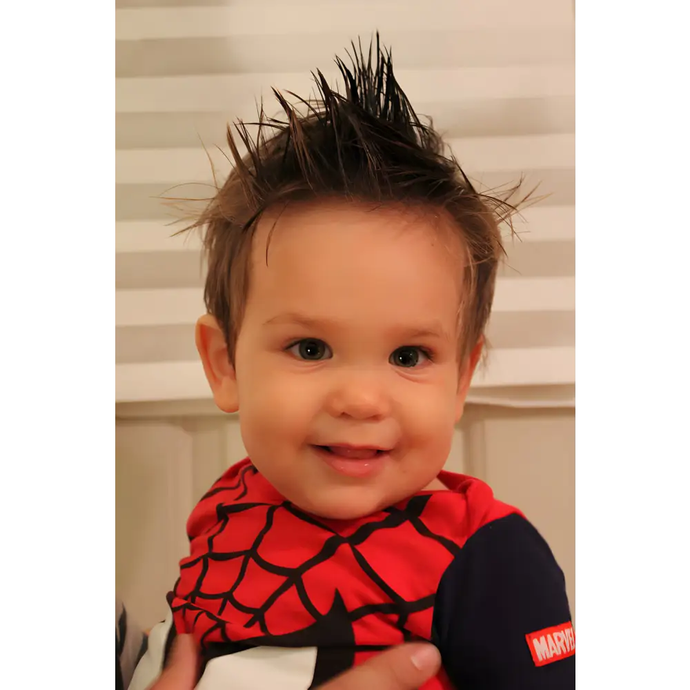 Smiling toddler in Spider-Man shirt with Spidey Hair Wax Fun Organic for awesome hair!