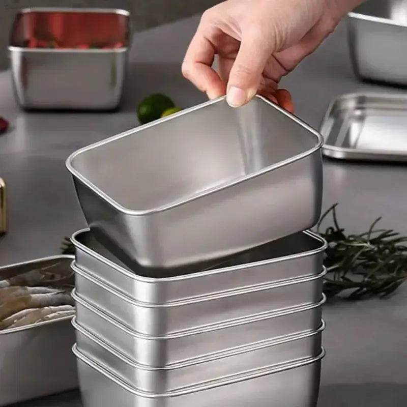 Stack of rectangular metal containers.