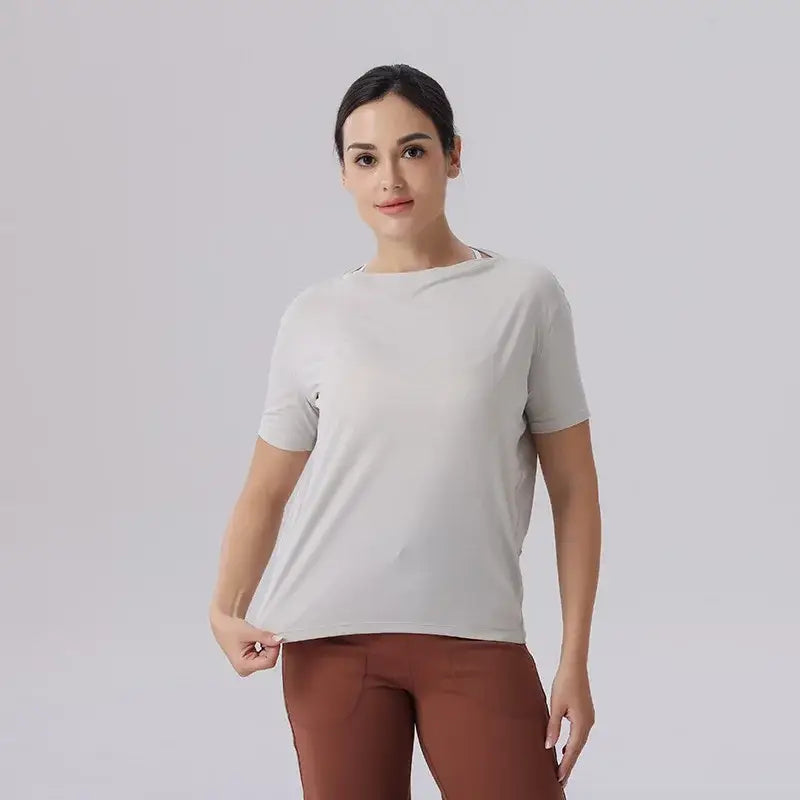 Woman in gray t-shirt and brown pants, showcasing Ice Silk Breathable Short Sleeved Yoga wear