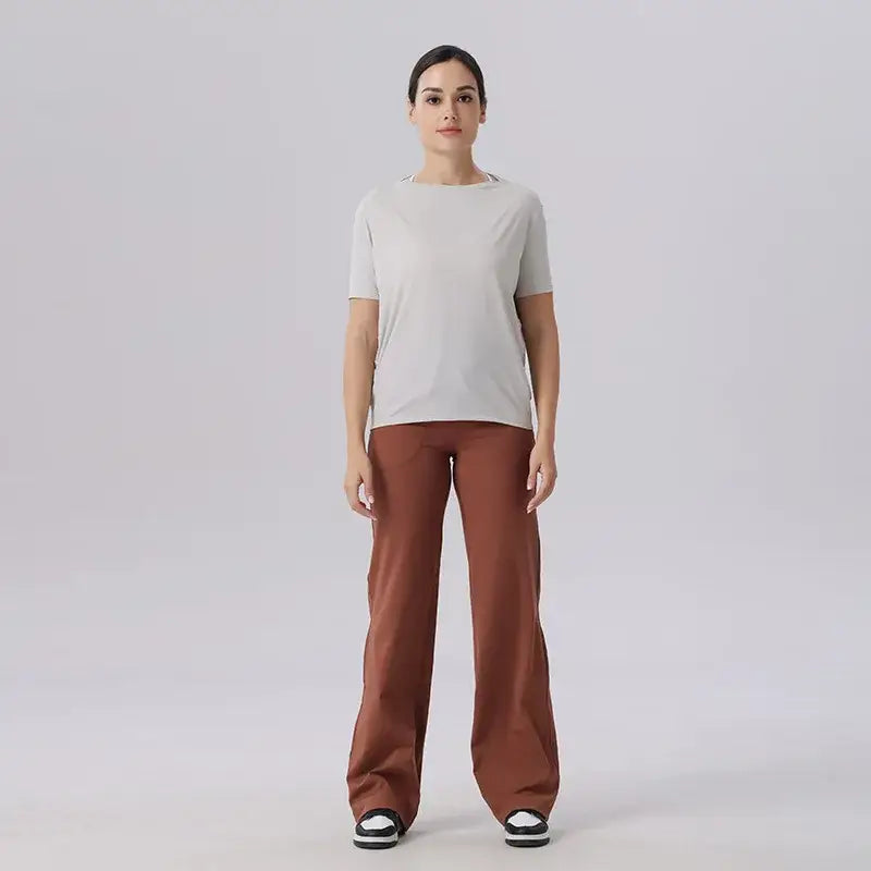 Woman in light t-shirt and brown pants showcasing Ice Silk Breathable Short Sleeved Yoga clothes