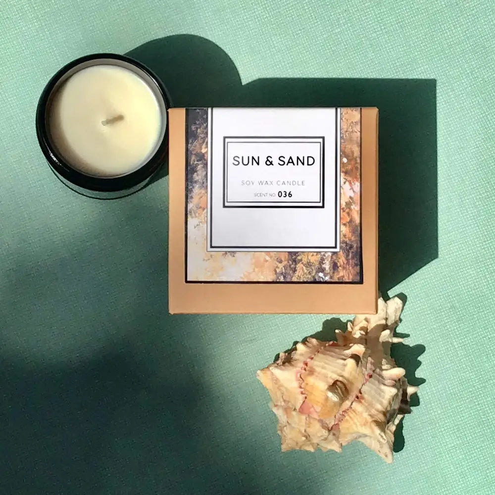 Sun + Sand Beachy Soy Candle with white flowers and a cozy sand soy wax vibe