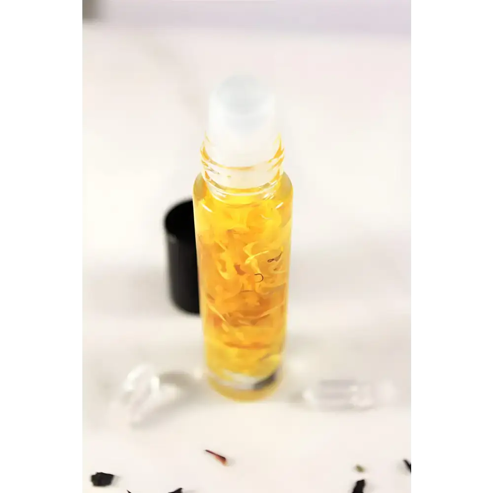 Sunny Flower Petal Perfume Oil in a clear roll-on bottle with yellow organic essential oil