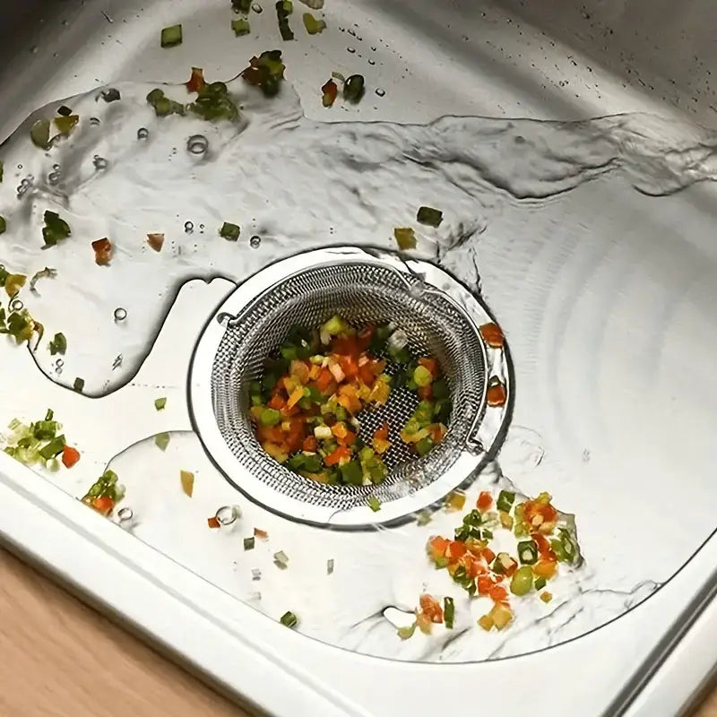 Stainless steel Super Sink Strainer filled with chopped veggies for a top drain hole filter