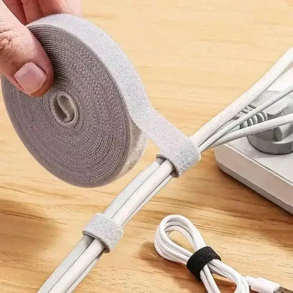 Roll of gray hook and loop fastener tape for cable management with Winder Tape