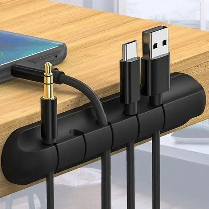 Black silicone USB cable organizer keeping cords tidy for a clutter-free desktop