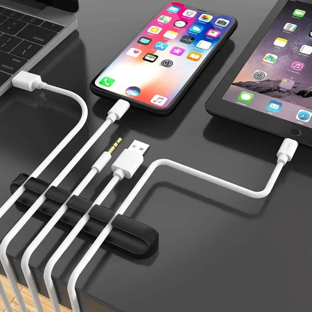 Silicone USB cable organizer holding multiple white cords for a tidy desktop setup