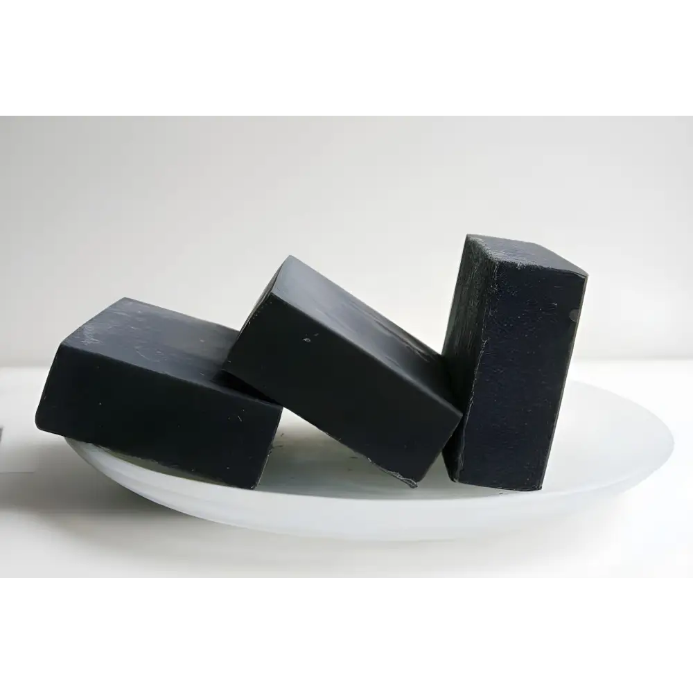 Three black rectangular soaps showcasing Triple Threat Activated Charcoal Soap