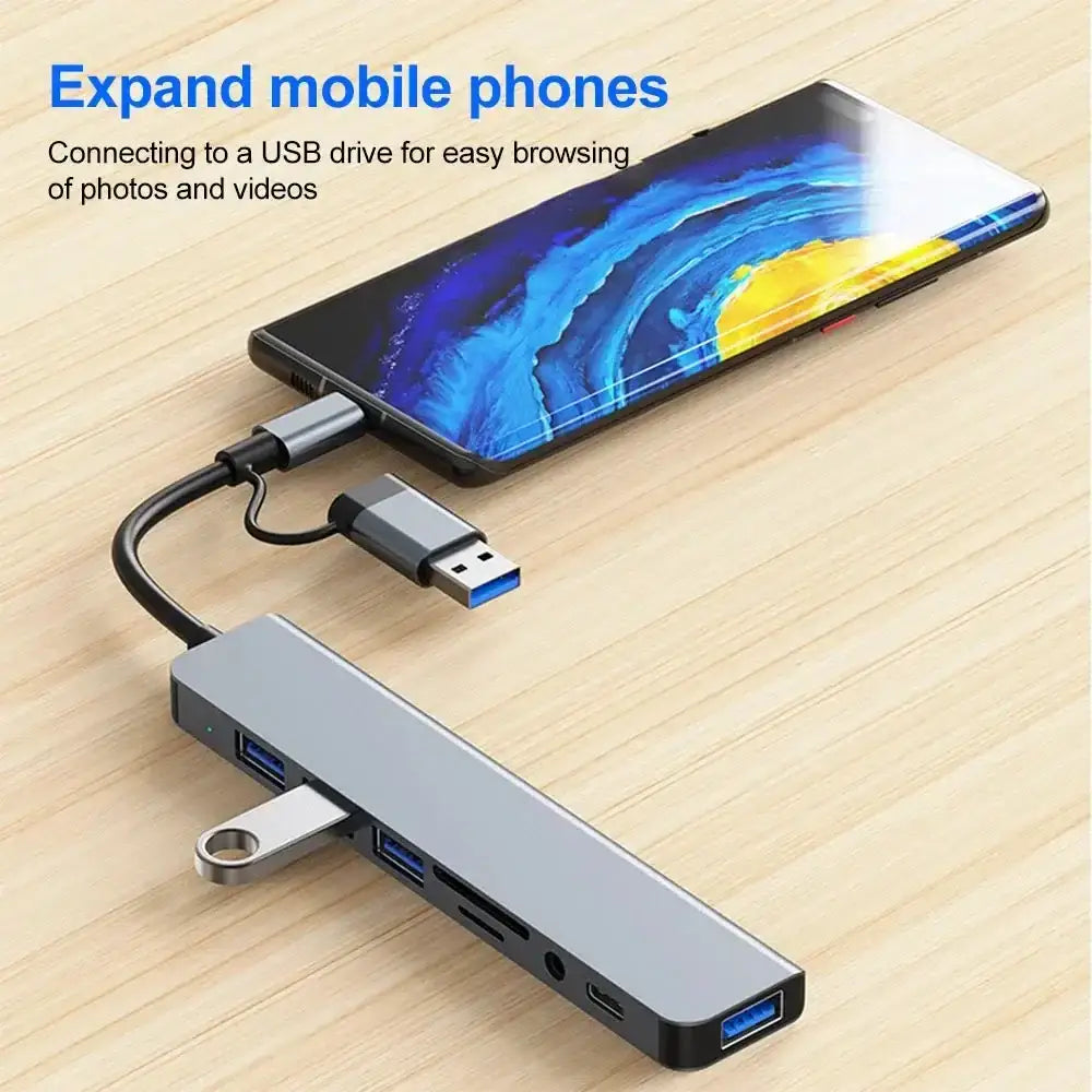 Silver USB-C hub connected to smartphone showcasing Ultimate USB Hub with multiple interface options