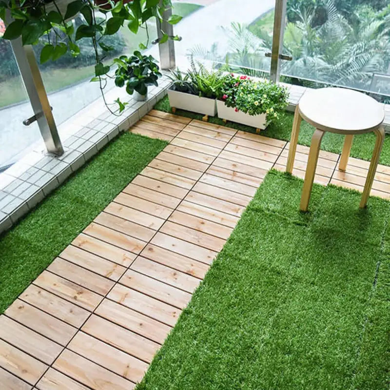 Balcony with artificial grass and wooden tiles.