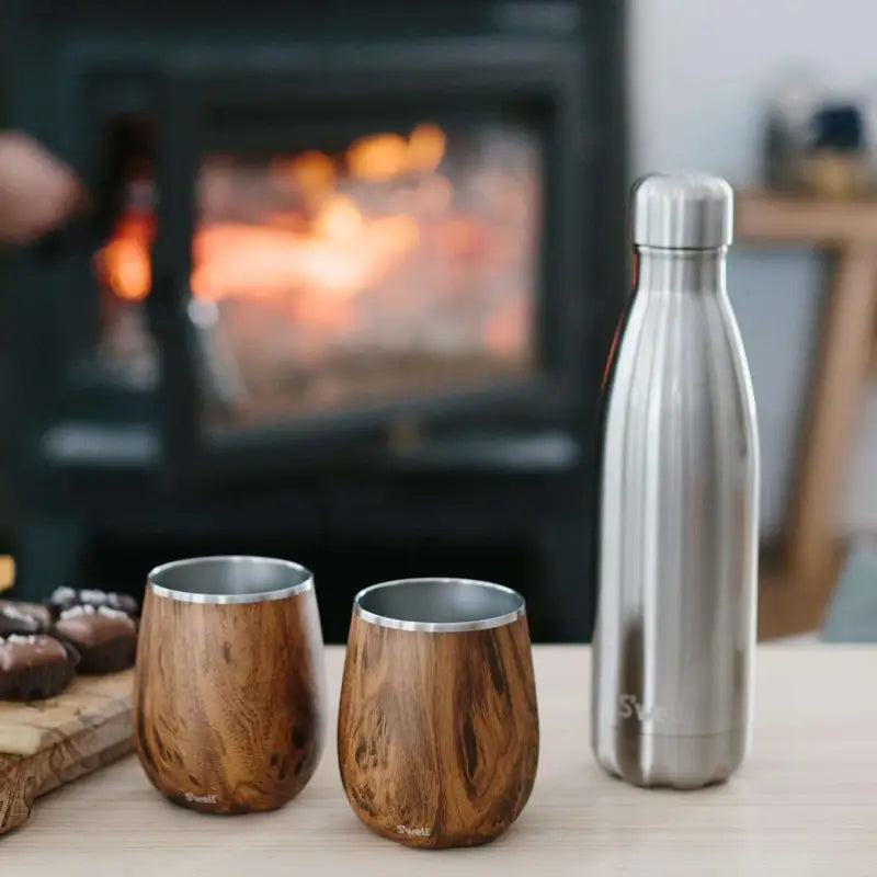 Two wood-patterned tumblers and a silver water bottle.