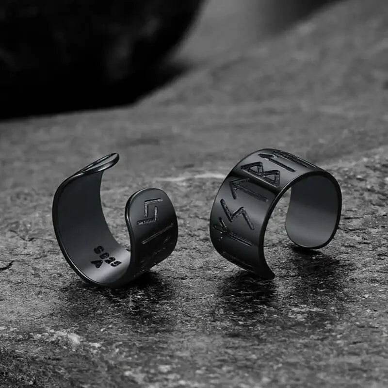 Two black rune-engraved ear cuffs.