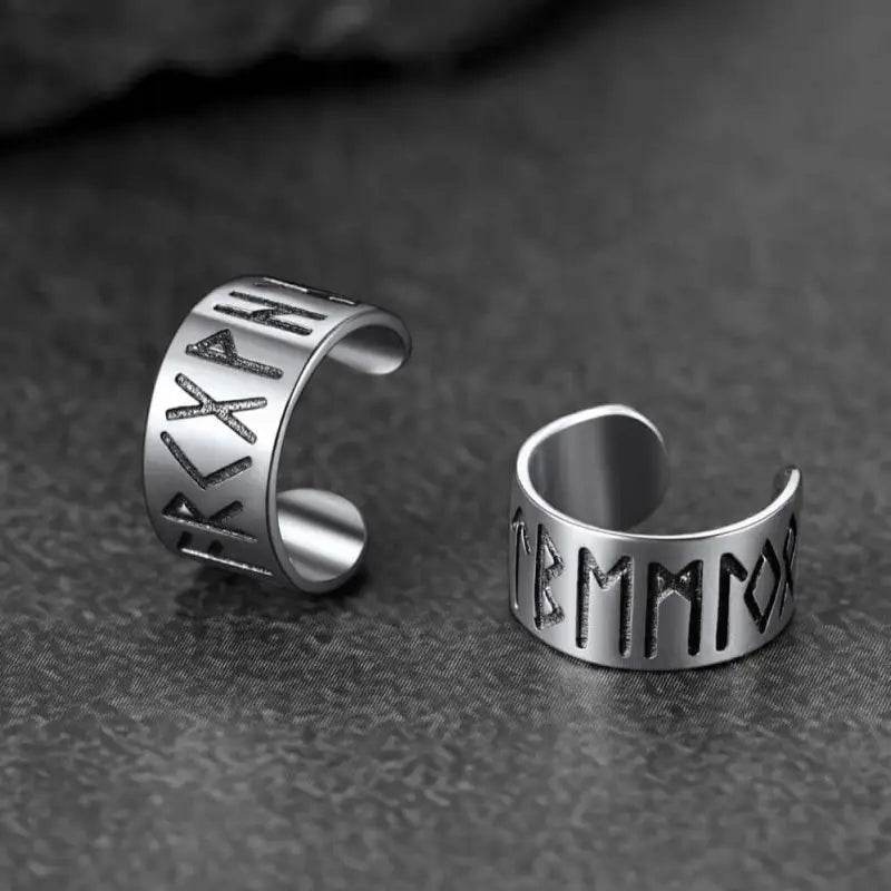 Two silver rune-engraved ear cuffs.