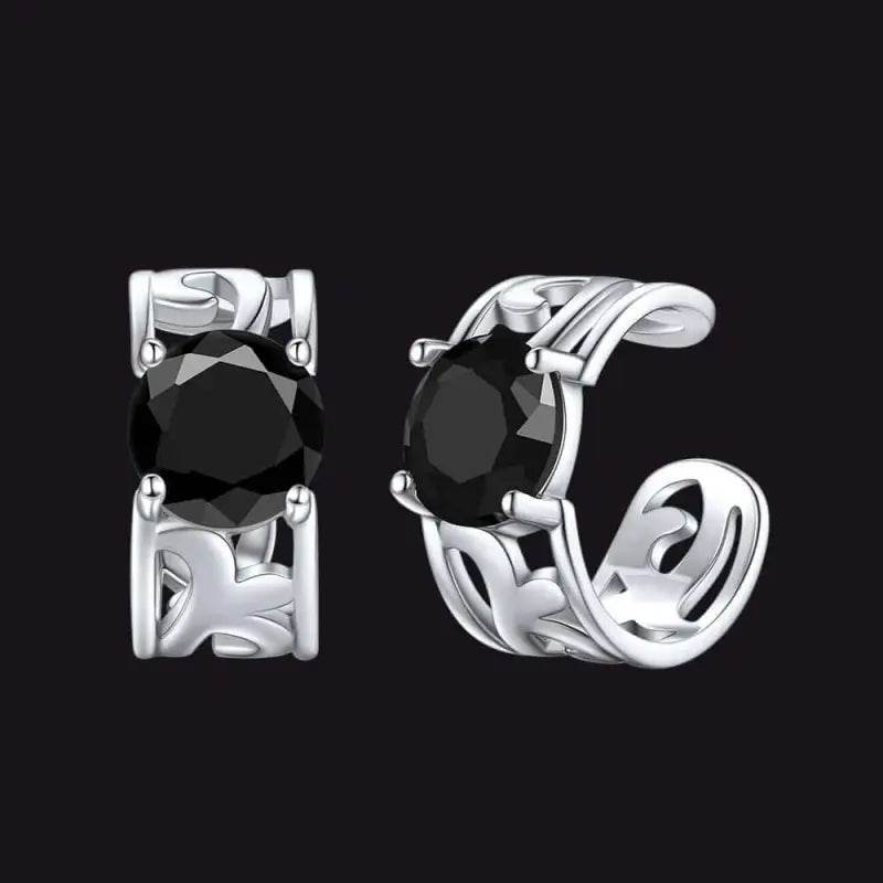Silver ear cuff earrings with black stones.