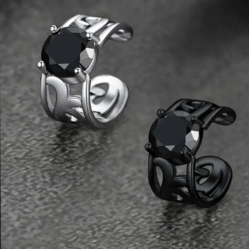 Two black gemstone ear cuffs.