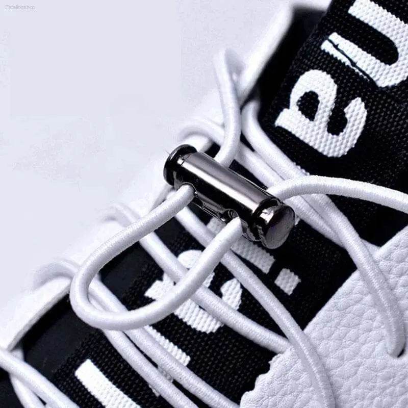 Black and white sneaker with metal lace lock.