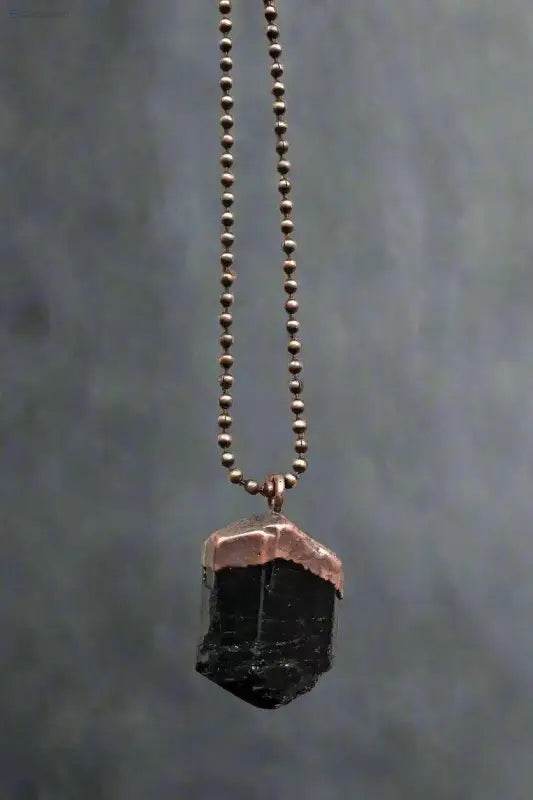 Black tourmaline pendant with copper cap and beaded chain.