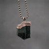 Black tourmaline pendant with copper electroforming.