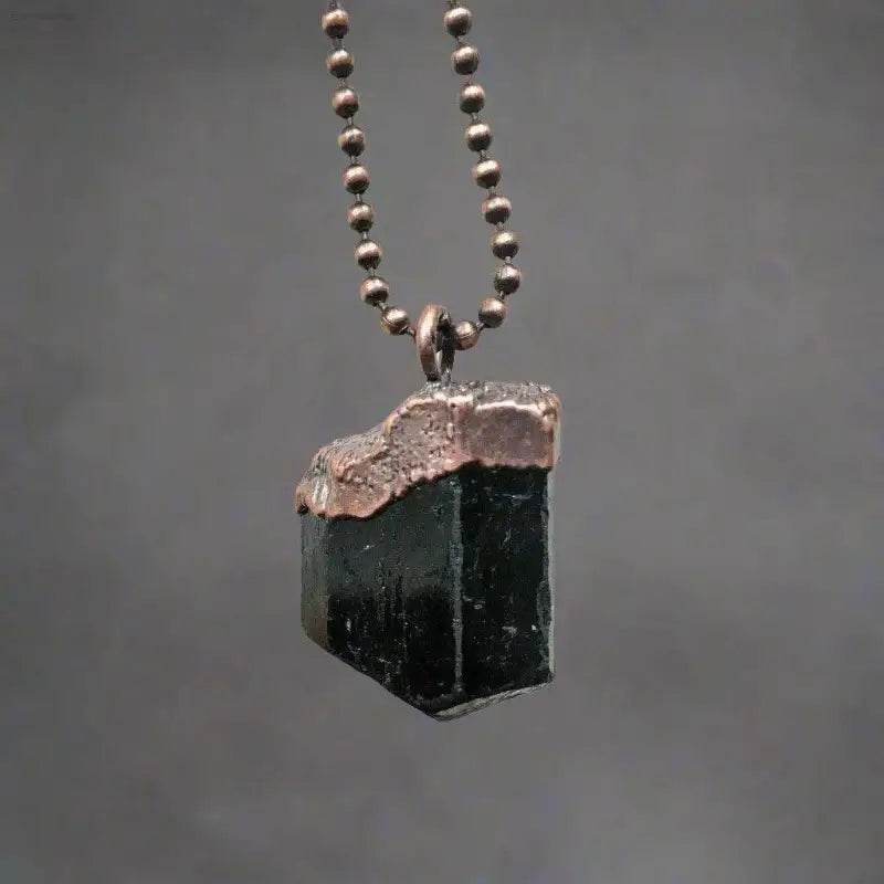 Black tourmaline pendant with copper electroforming.