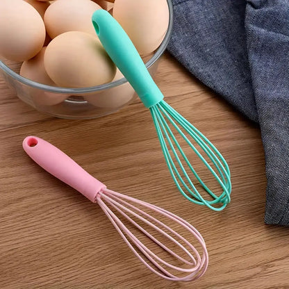 Two colorful Vibrant Mini Silicone Whisks, a must-have silicone whisk essential