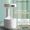 White anti-gravity humidifier with digital clock.
