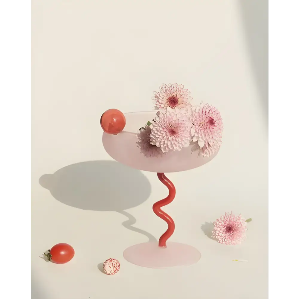 Pink glass with red spiral stem for a Whimsical Eclectic Dopamine Dessert Dream cocktail