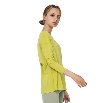 Woman in chartreuse long-sleeved shirt, perfect for fast dry running and loose yoga clothes