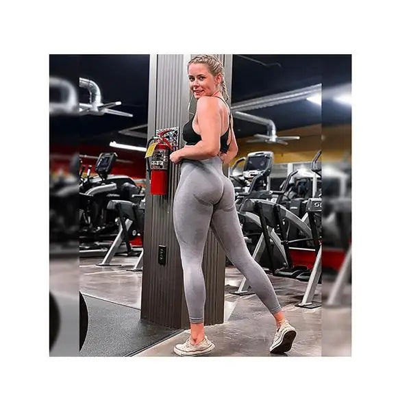 Woman in yoga gym leggings, showcasing stylish high waist workout tights for fitness